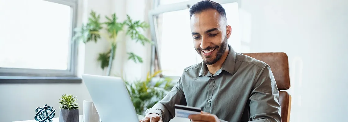 A man using a credit card to shop online