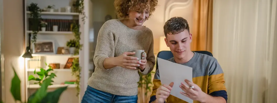 A smiling couple looking at a paper together