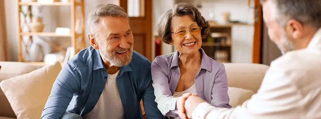Three older people meeting together.