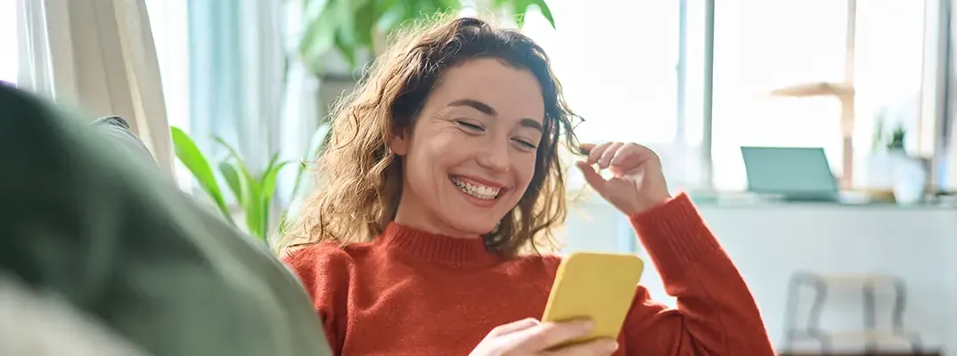 Woman looking at her phone and smiling