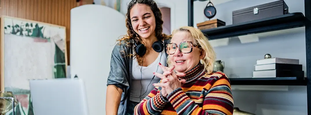 Two women working on a laptop together