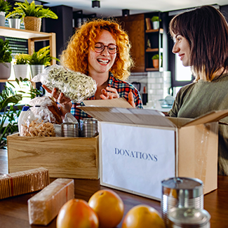 Two women handling food donations
