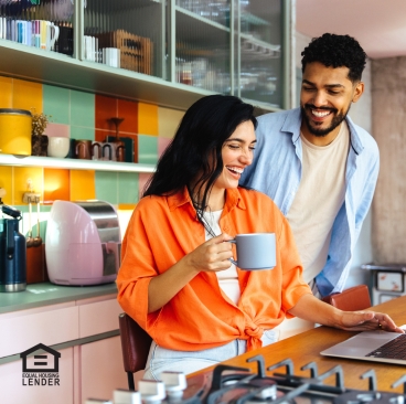 A couple smiling in a kitchen