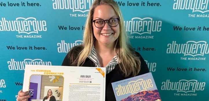 Ann Baur, Senior Vice President of Retail Experience at Sunward Federal Credit Union, holding her Albuquerque The Magazine article.