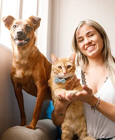 A woman with a dog and cat