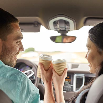 Couple With Coffee Driving