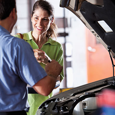 Woman getting her car fixed