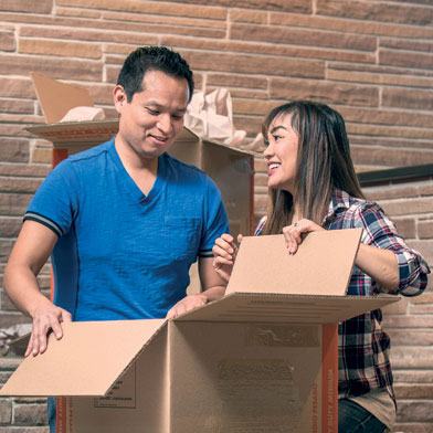 Couple at home unpacking