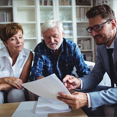 Financial advisor meeting with couple and going over paperwork