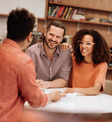 A young couple talking to a financial representative