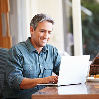 smiling man using a computer