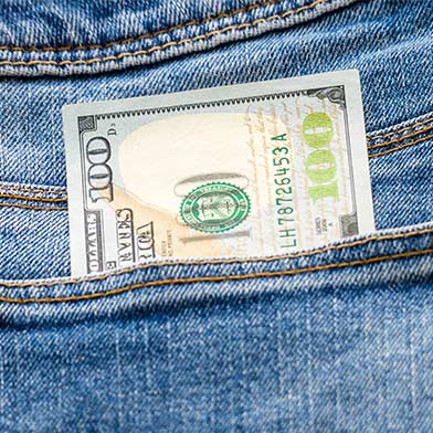 Hundred dollar bill inside of a jeans pocket