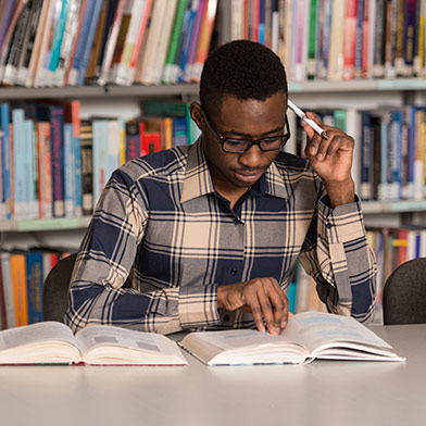 Young man studying in a library.