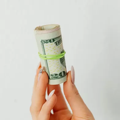 Close up of a person's hand holding money