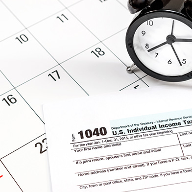 Tax paperwork with an analog clock on top