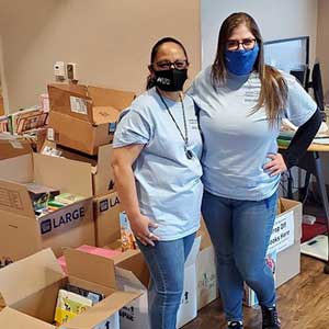 Pictured are Sunward employees Kimberley Craft and Dolores Cotinola collecting childrenâs books during our drive-thru book drop-off on April 17.