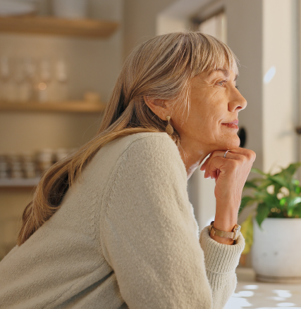 A woman looking thoughtfully out a window