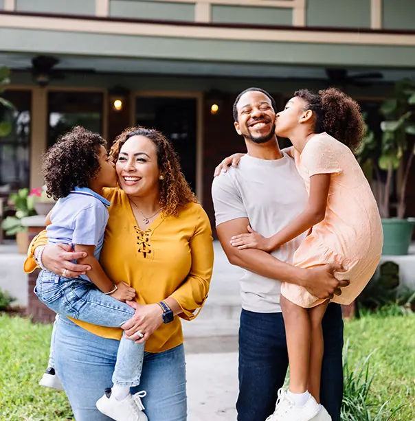 A happy family in front of their home