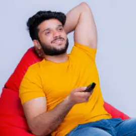 A man holding a remote control while relaxing